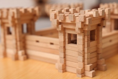 Photo of Wooden fortress on table, closeup. Children's toy