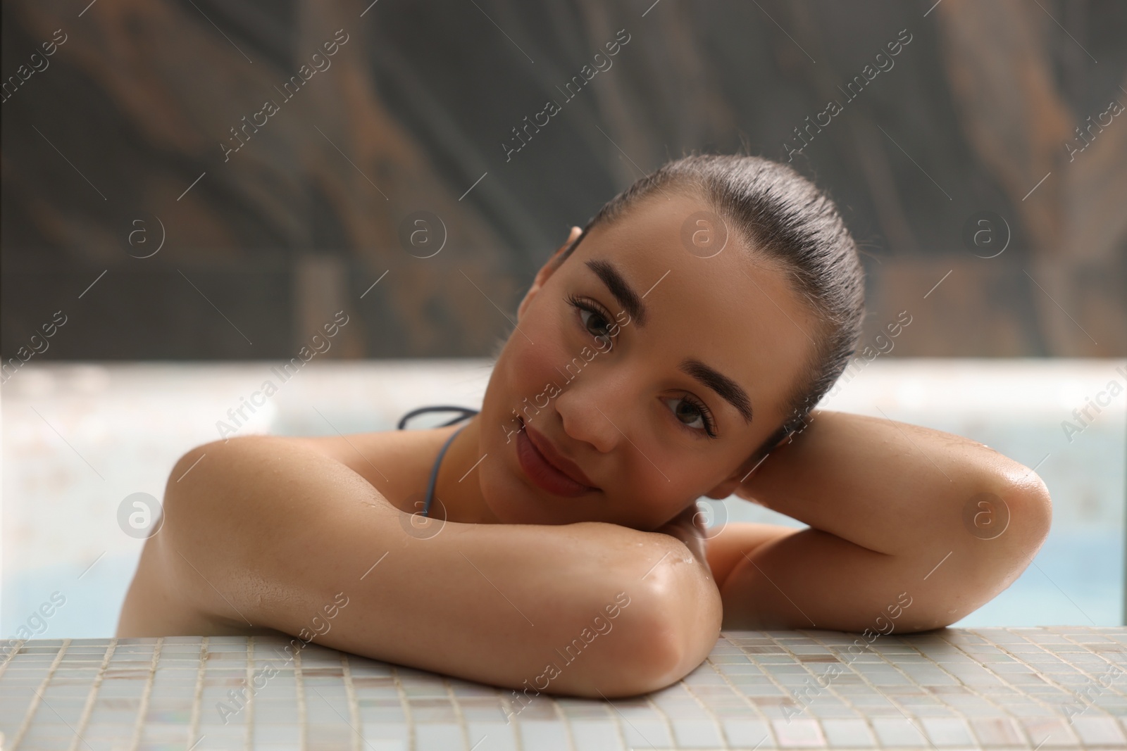 Photo of Beautiful woman relaxing in spa swimming pool