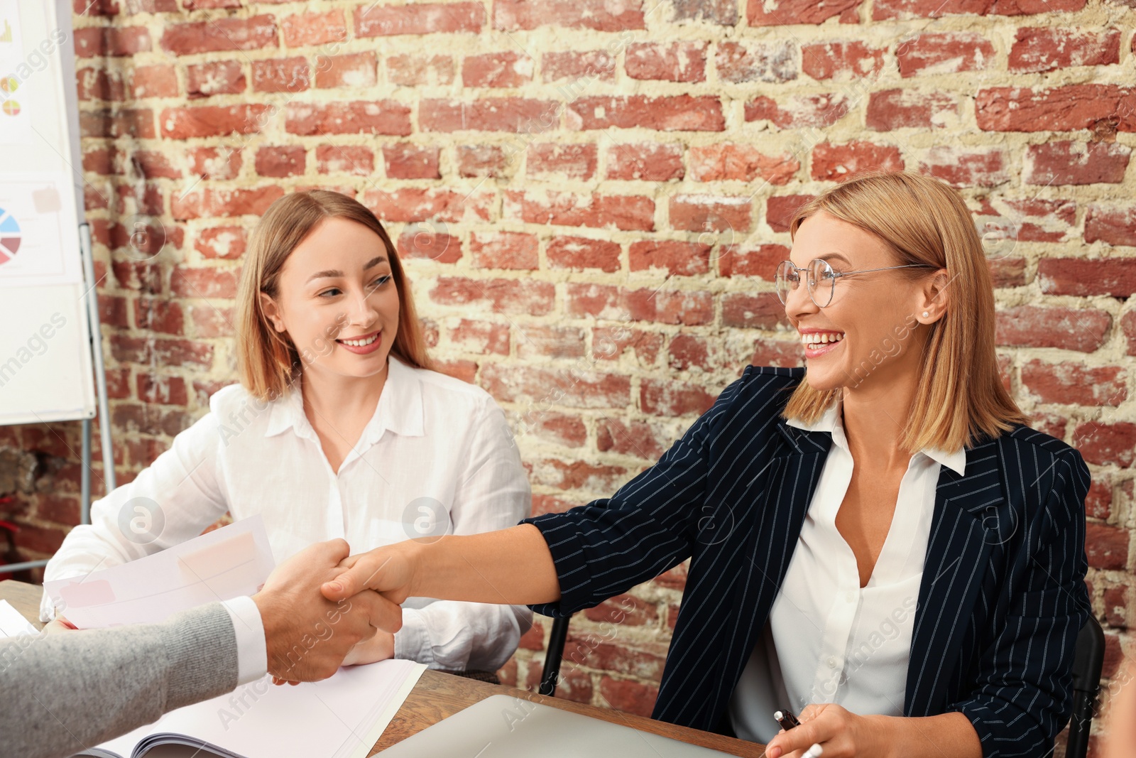 Photo of Businesswoman having meeting with her employees in office. Lady boss