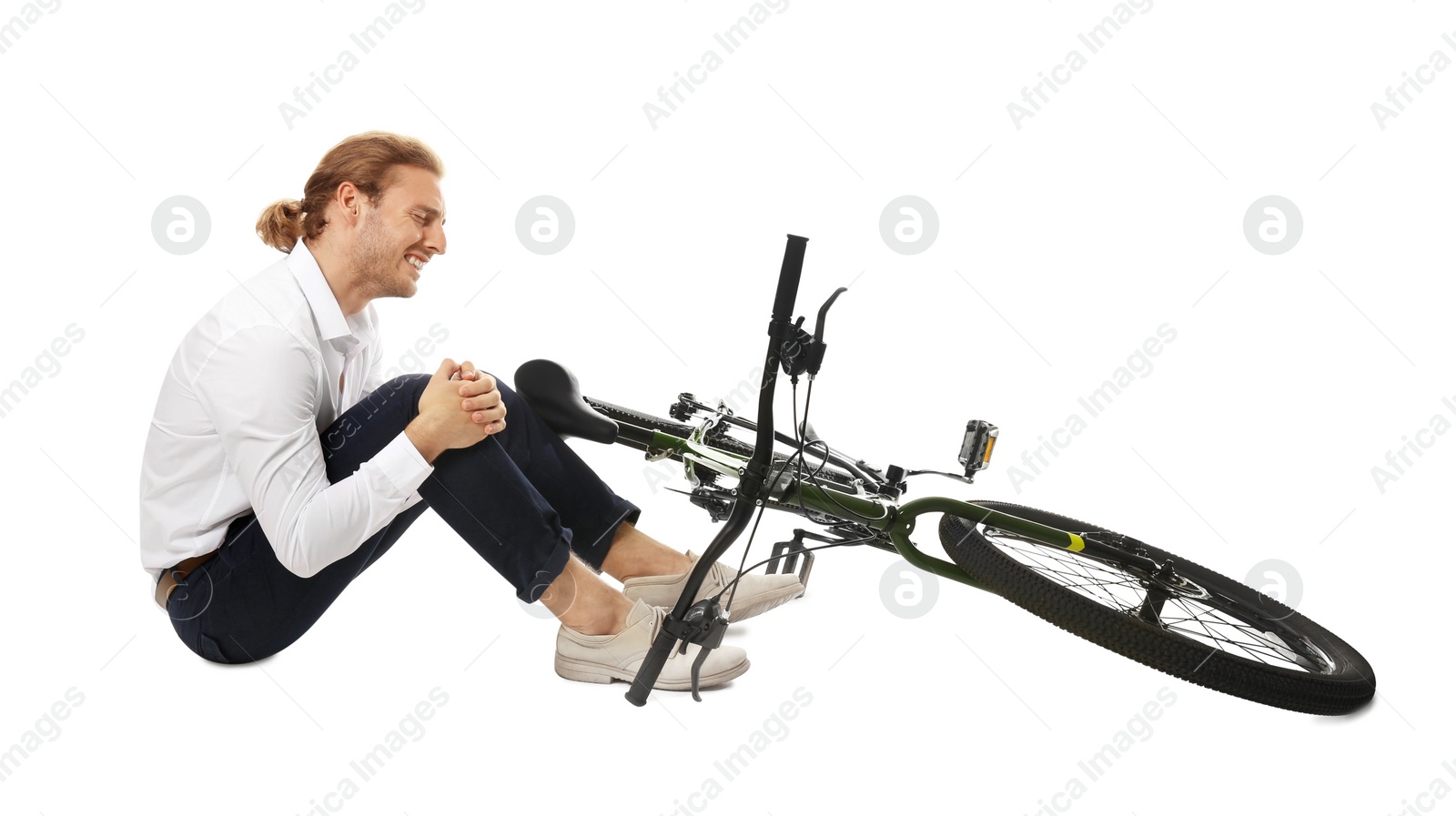 Photo of Young man with injured leg near bicycle on white background