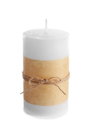 Photo of New wax candle decorated with parchment on white background