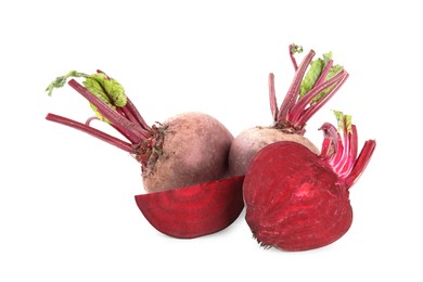 Photo of Whole and cut ripe beetroots on white background