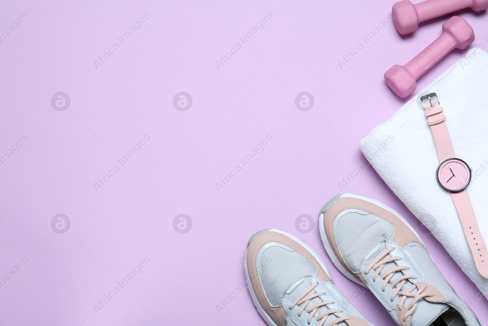Photo of Flat lay composition with woman's sneakers and fitness items on lilac background, space for text