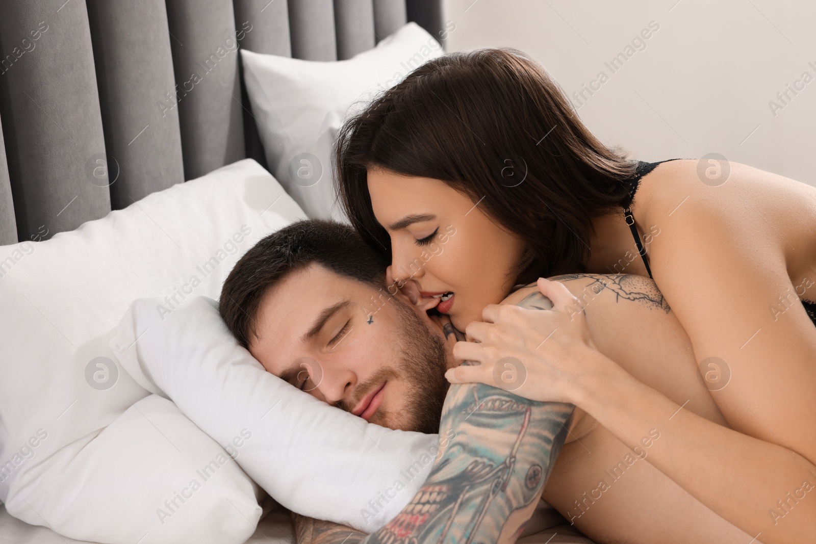 Photo of Passionate couple having sex on bed at home