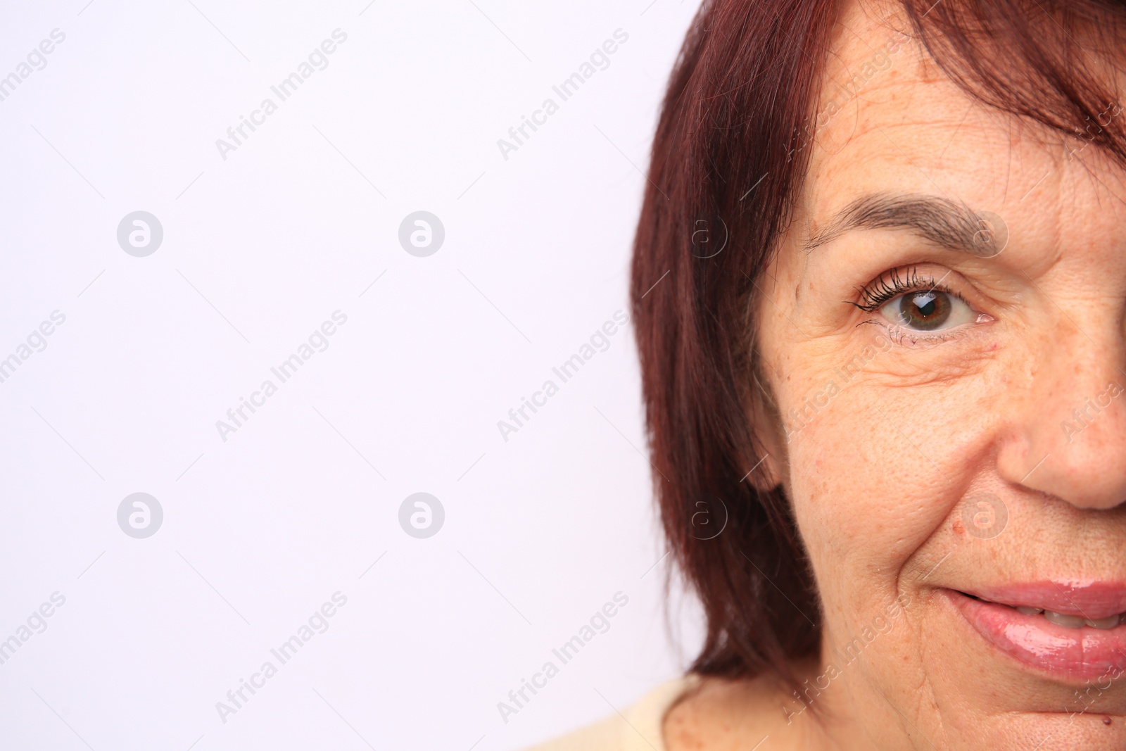 Photo of Skin care. Senior woman on white background, closeup. Space for text