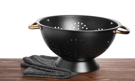 Photo of Black empty colander and napkin on wooden table against white background