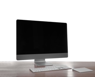 Photo of Modern computer with blank monitor screen and peripherals on wooden table against white background