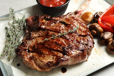Photo of Delicious grilled ribeye with garnish, closeup view