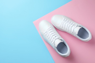 Photo of Pair of sneakers on color background, flat lay. Space for text