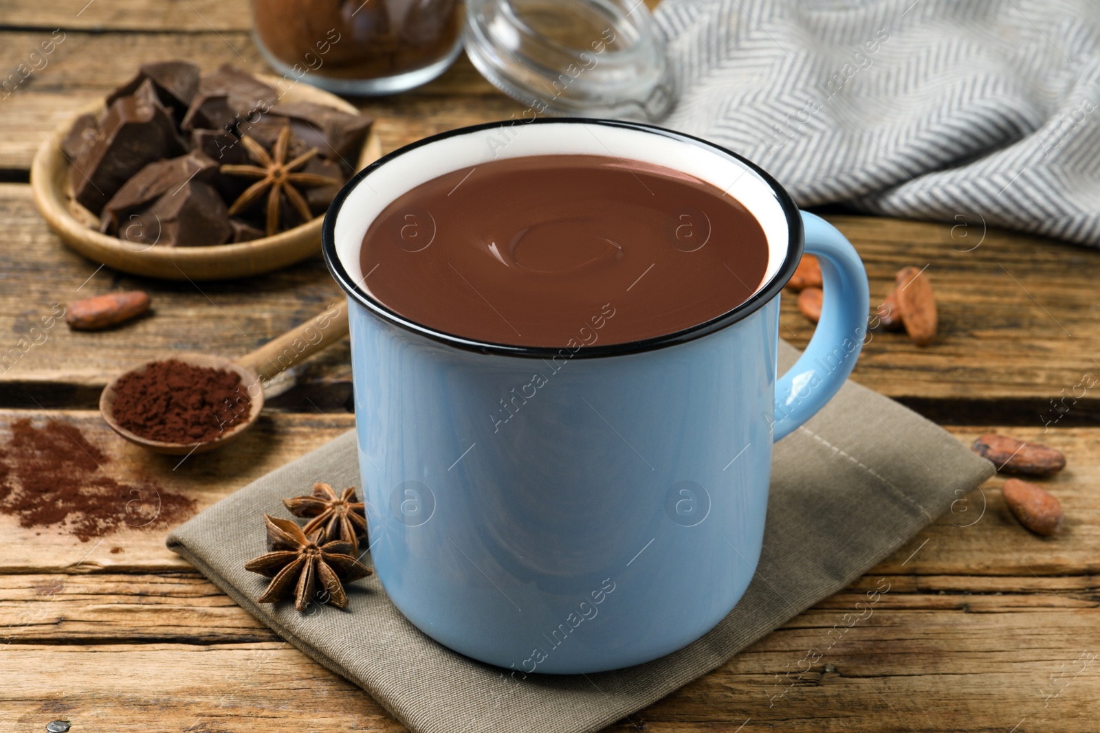 Photo of Yummy hot chocolate in mug on wooden table