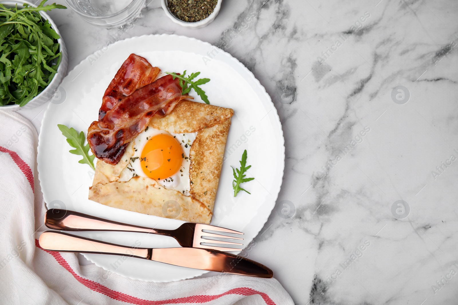 Photo of Delicious crepe with egg served on white marble table, flat lay with space for text. Breton galette