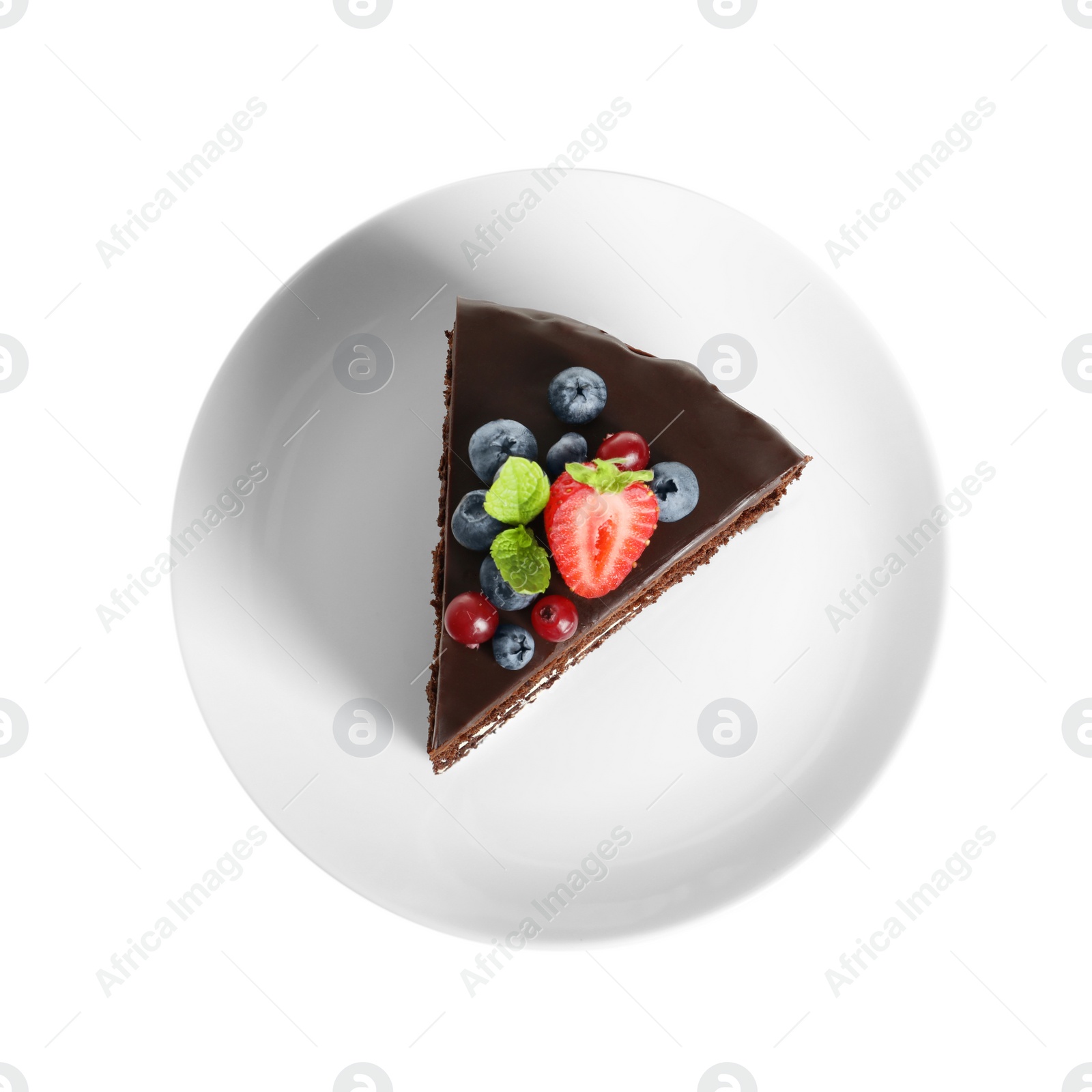 Photo of Plate with slice of chocolate sponge berry cake on white background, top view