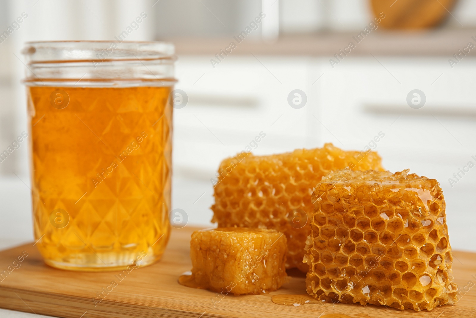 Photo of Composition with fresh honey on wooden board, closeup