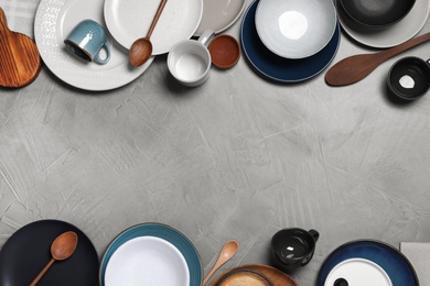 Photo of Flat lay composition with dishware on light grey table. Space for text