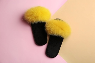 Photo of Pair of soft slippers on color background, flat lay