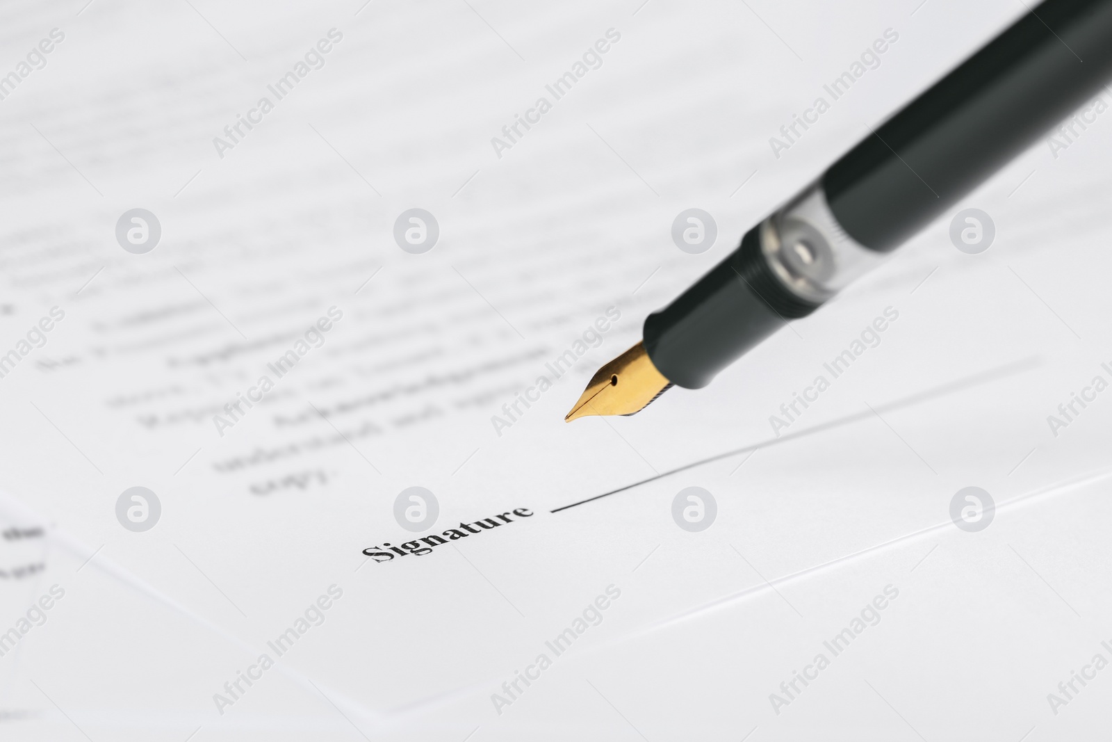 Photo of Signing notary document with fountain pen, closeup. Space for text