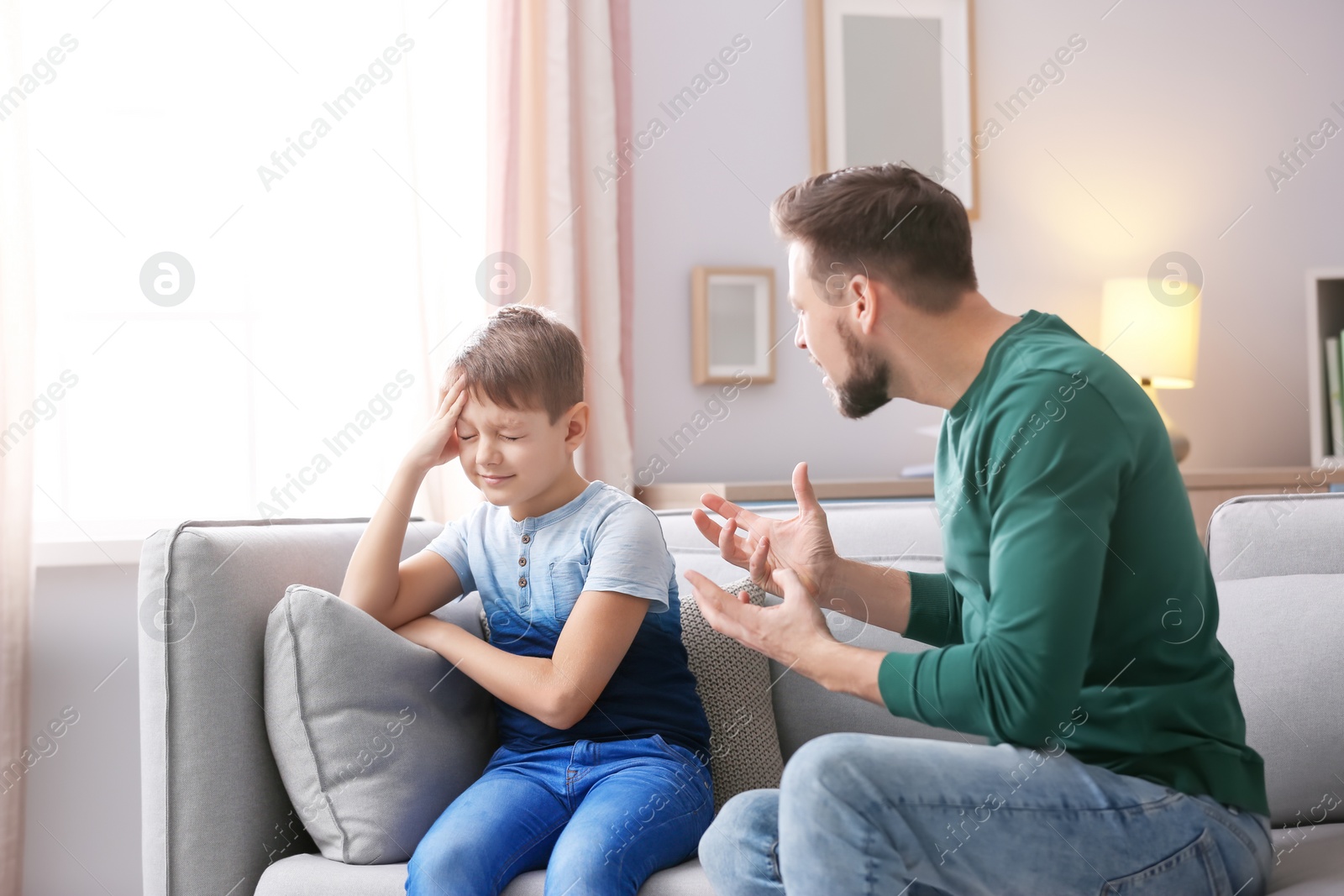 Photo of Father arguing with son at home