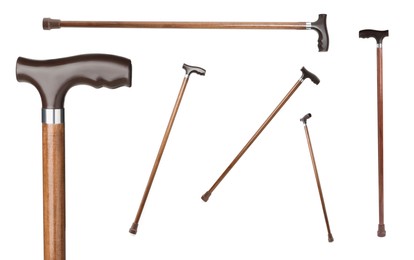 Image of Set with elegant wooden walking canes on white background