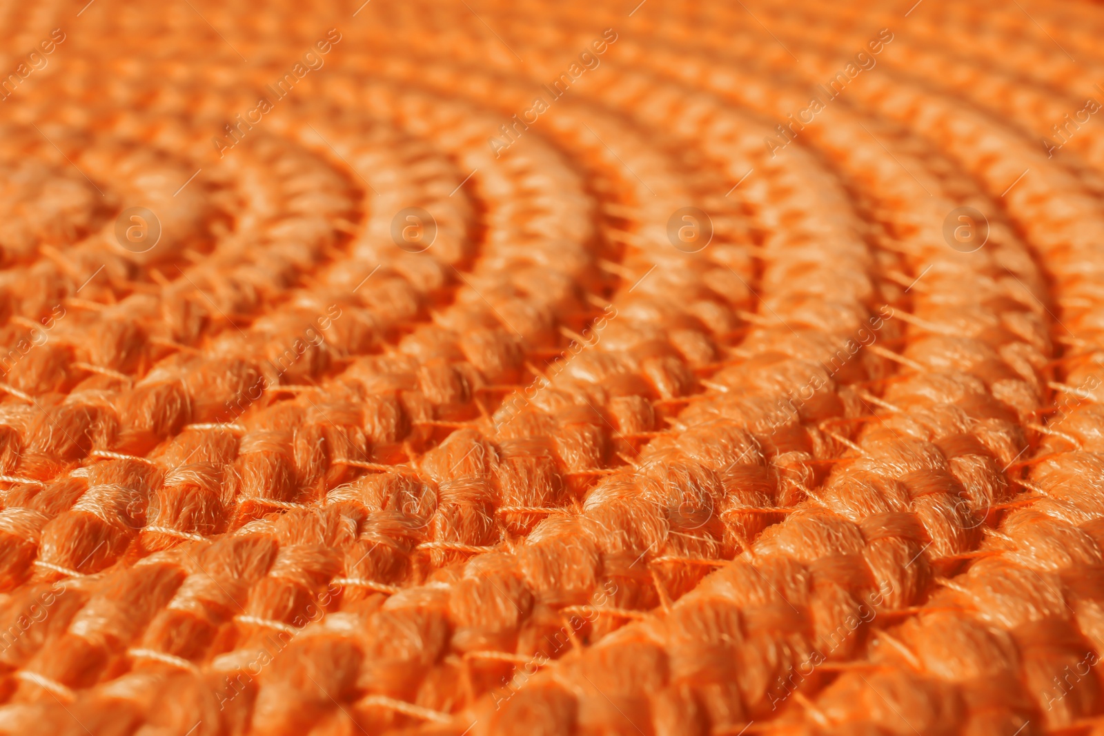 Photo of Orange wicker mat texture as background, closeup