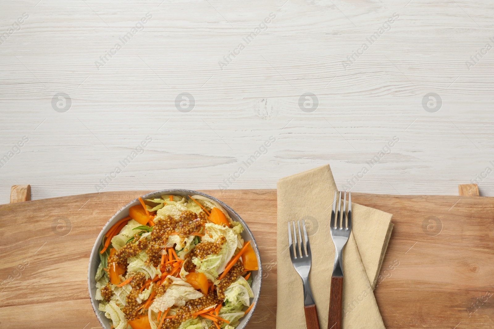 Photo of Delicious salad with Chinese cabbage and mustard seed dressing on white wooden table, top view. Space for text