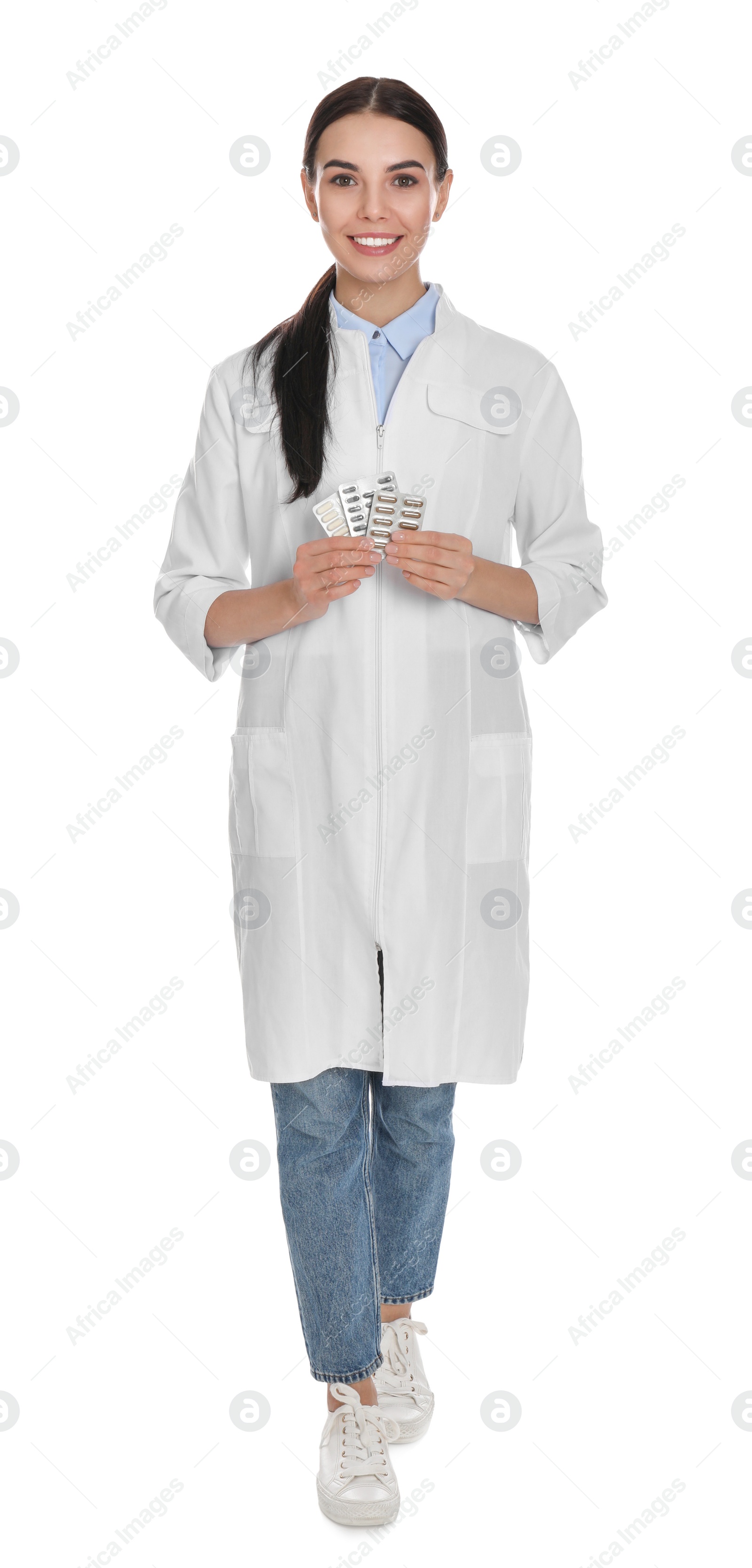 Photo of Professional pharmacist with pills on white background