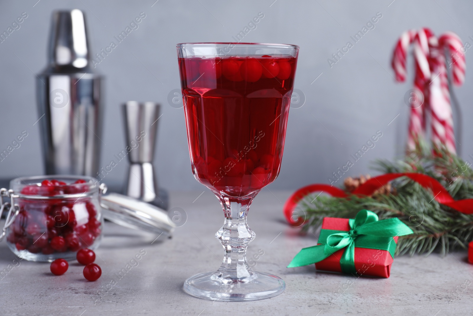 Photo of Delicious Christmas liqueur on grey table, closeup