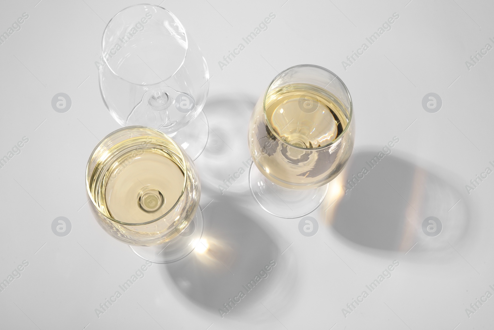 Photo of Tasty aromatic wine in glasses isolated on white