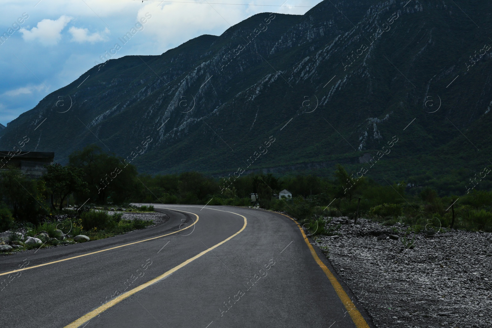 Photo of Beautiful view of empty asphalt highway near mountains outdoors. Road trip