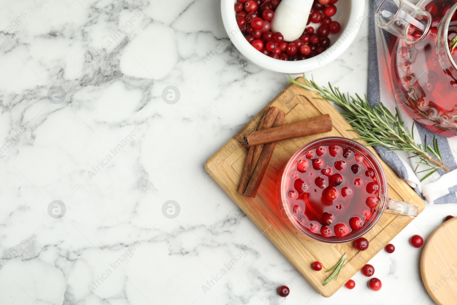 Photo of Flat lay composition with tasty hot cranberry tea and fresh ingredients on white marble table. Space for text