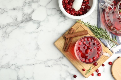 Photo of Flat lay composition with tasty hot cranberry tea and fresh ingredients on white marble table. Space for text