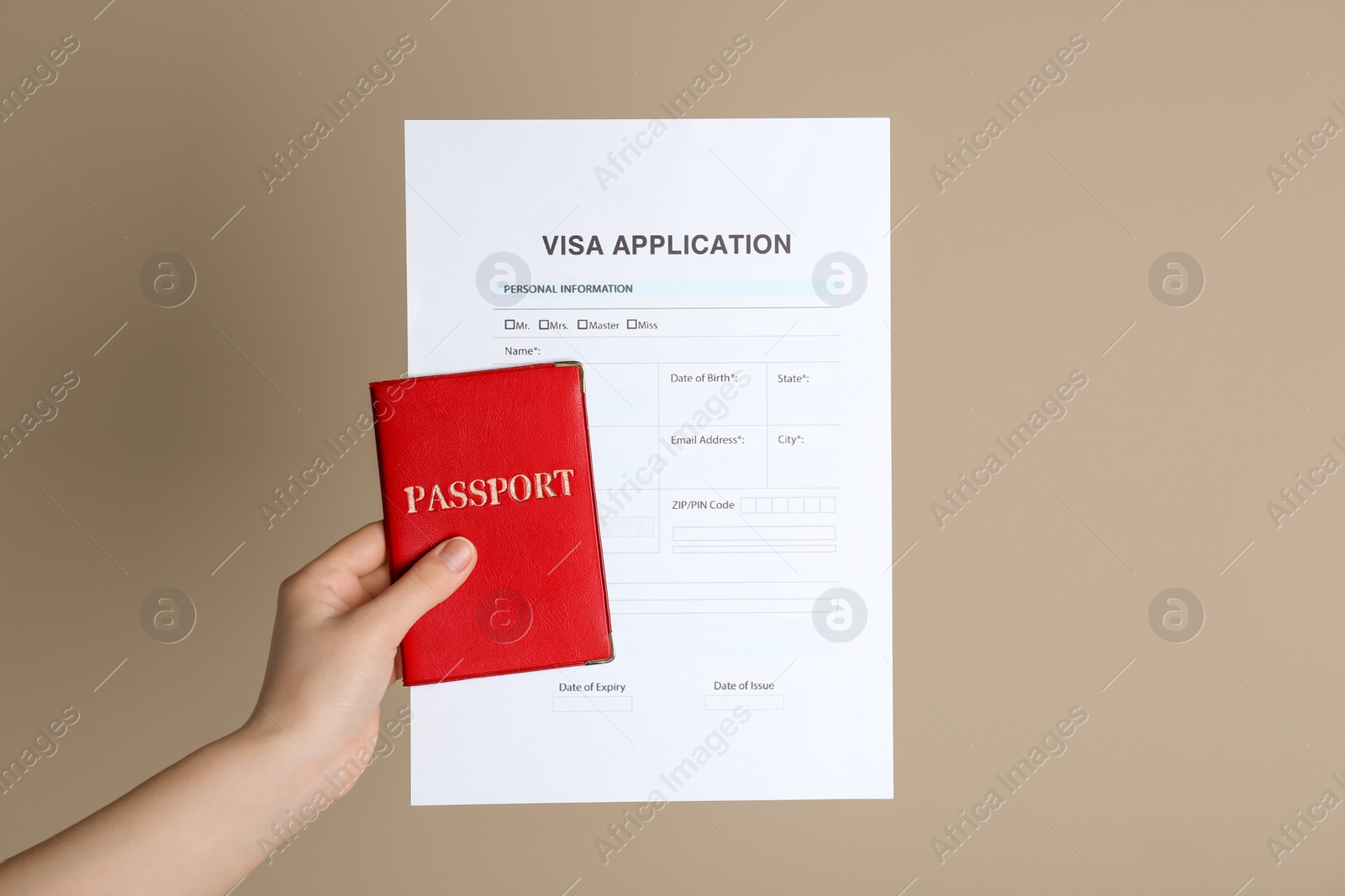 Photo of Woman holding visa application form for immigration and passport on beige background, closeup