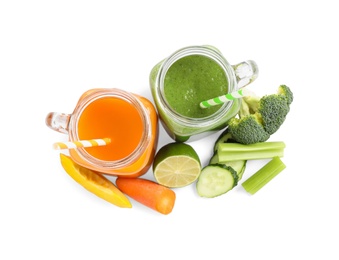 Delicious vegetable juices and fresh ingredients on white background, top view