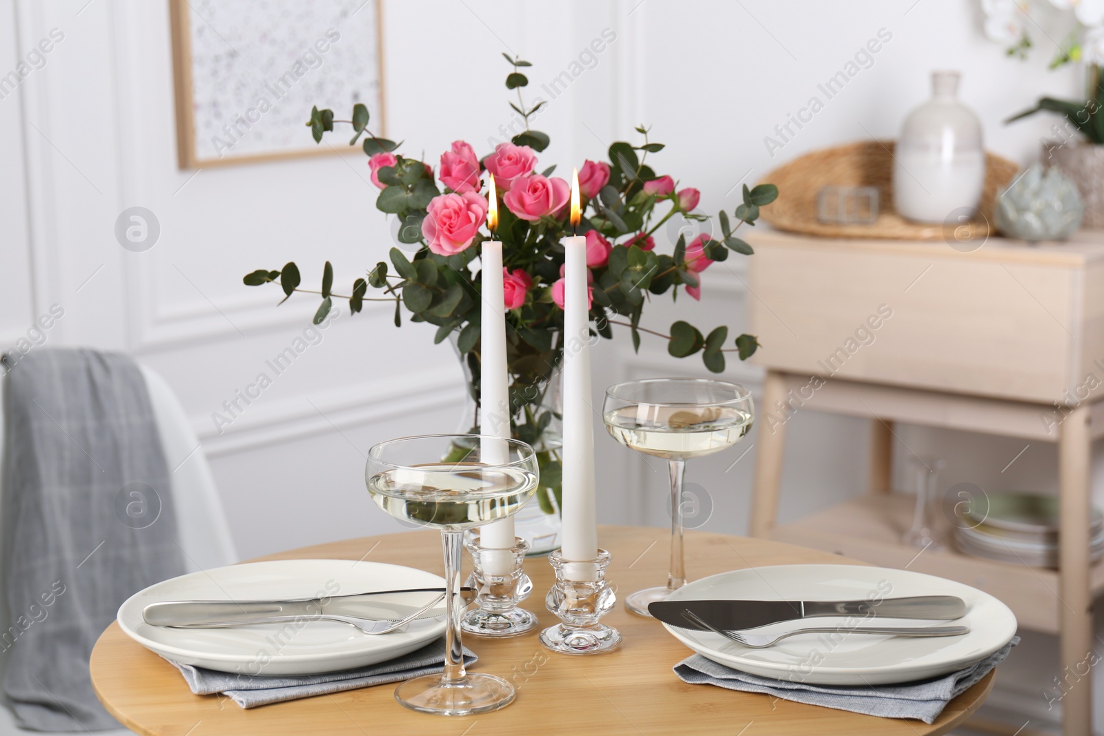 Photo of Romantic table setting with candles and flowers