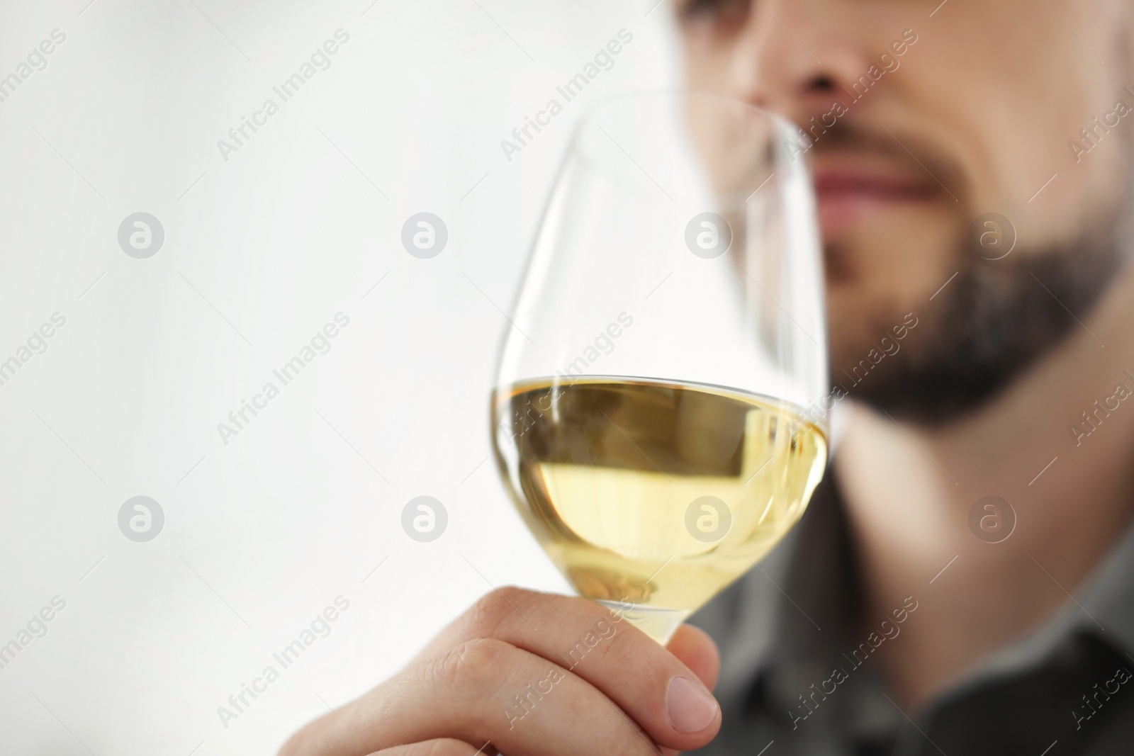 Photo of Man with glass of delicious wine indoors