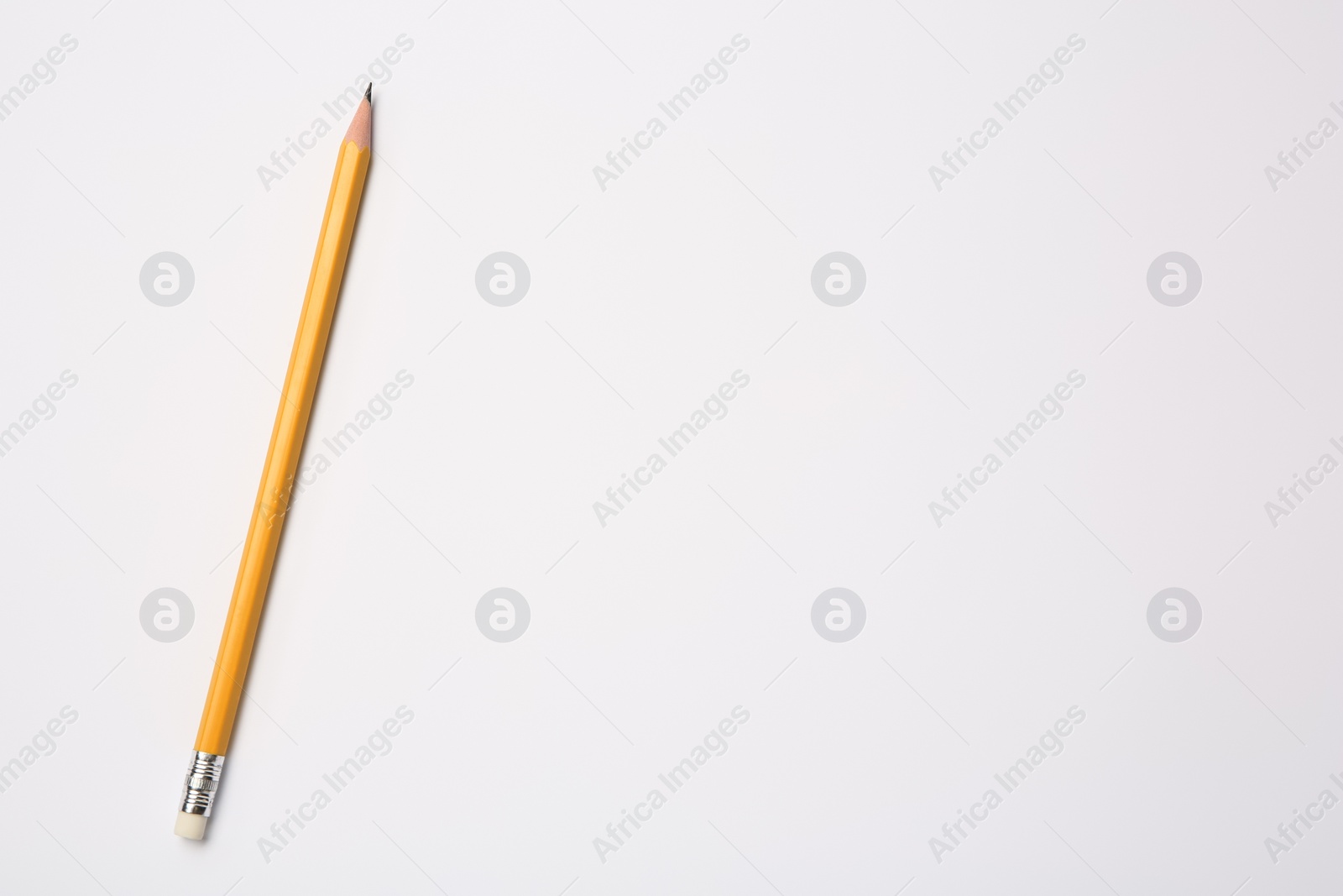 Photo of Sharp graphite pencil on white background, top view. Space for text