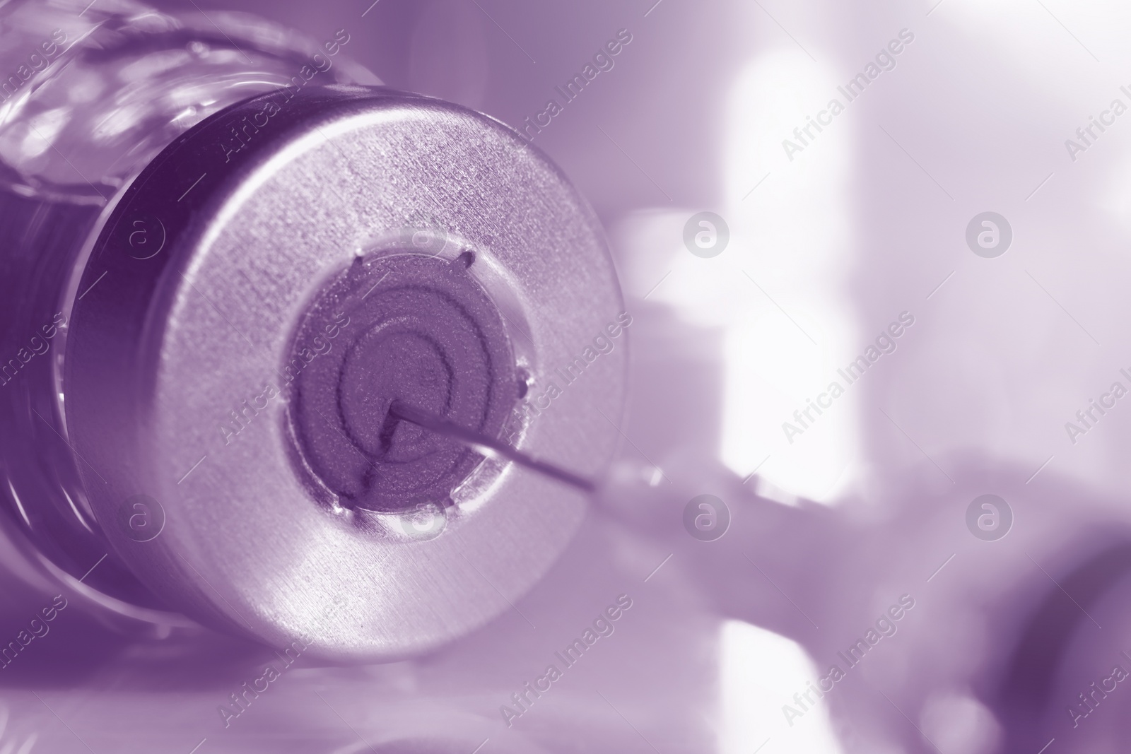 Image of Filling syringe with medicine from vial on table, closeup. Color toned