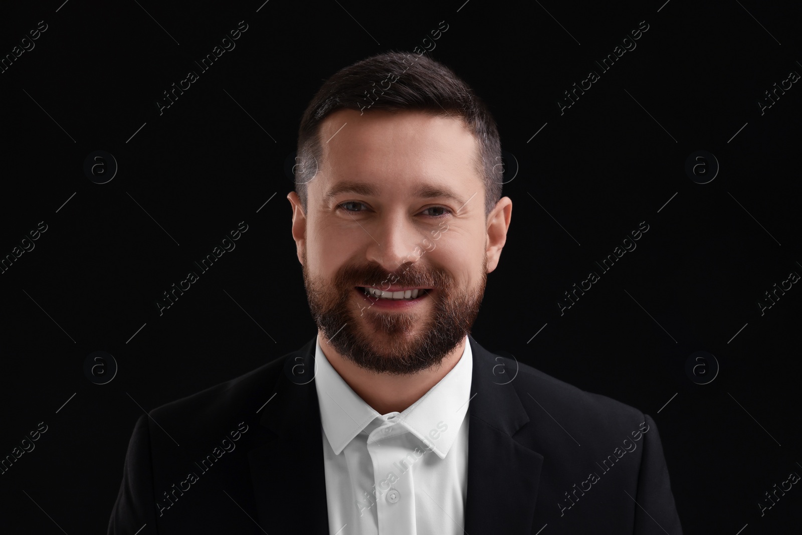 Photo of Personality concept. Happy man on black background