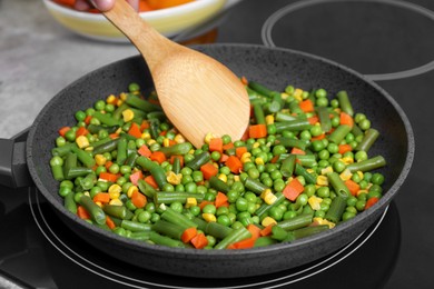 Photo of Cooking tasty vegetable mix in frying pan, closeup