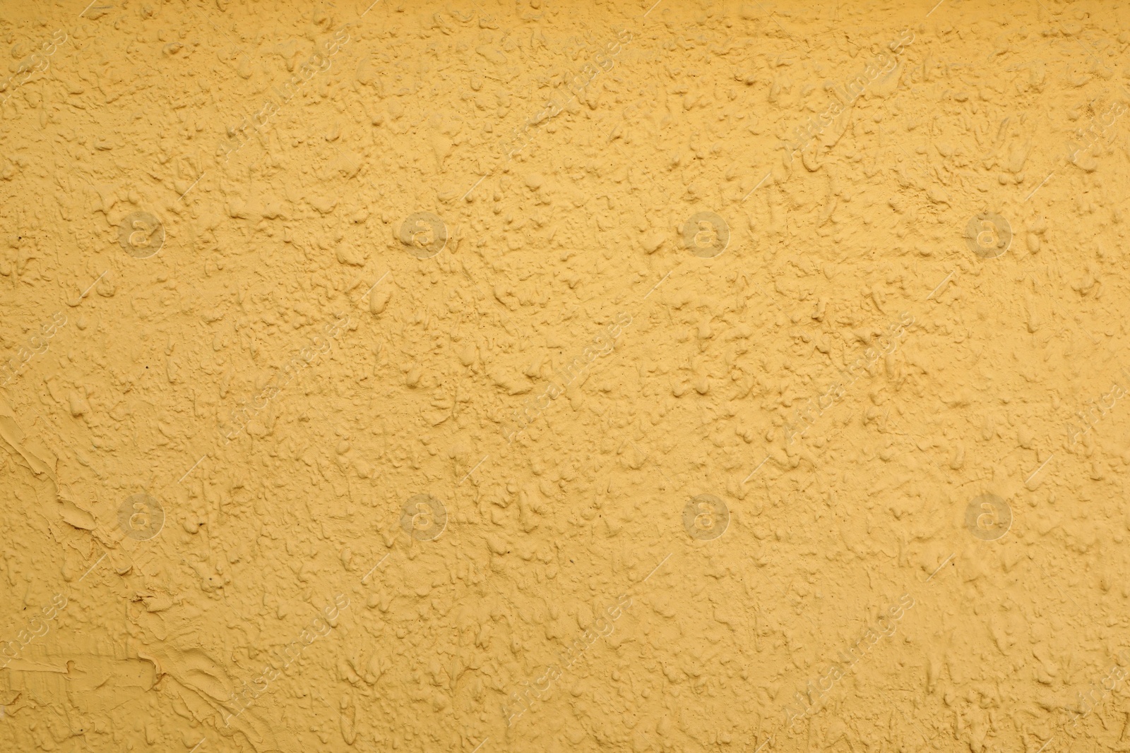 Photo of Texture of yellow plaster wall as background