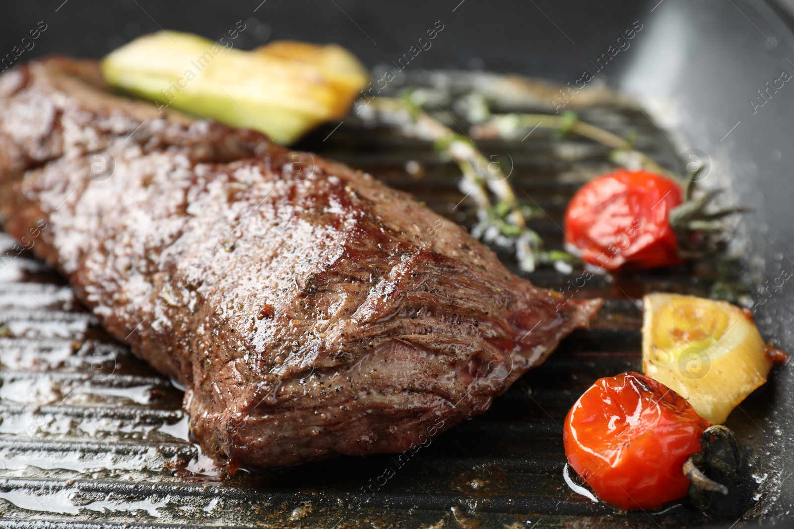 Photo of Delicious grilled beef meat and vegetables in pan, closeup