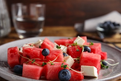 Photo of Delicious salad with watermelon, blueberries and feta cheese on plate, closeup
