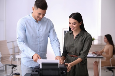 Photo of Employees using new modern printer in office