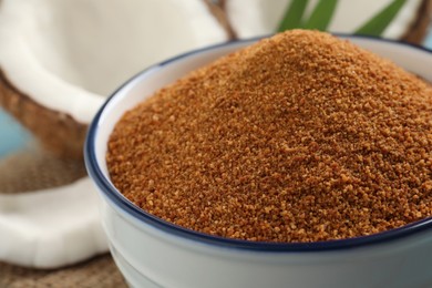 Photo of Natural coconut sugar in ceramic bowl, closeup