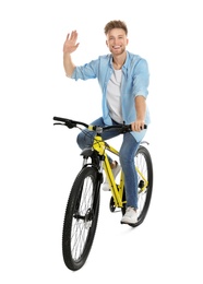 Photo of Handsome young man riding bicycle on white background