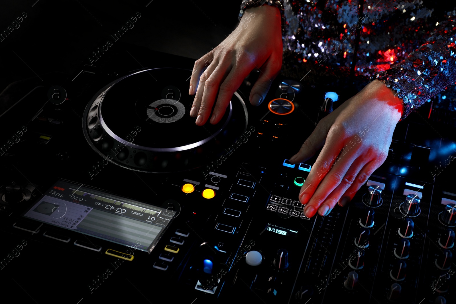 Photo of DJ creating music on modern console mixer in night club, closeup