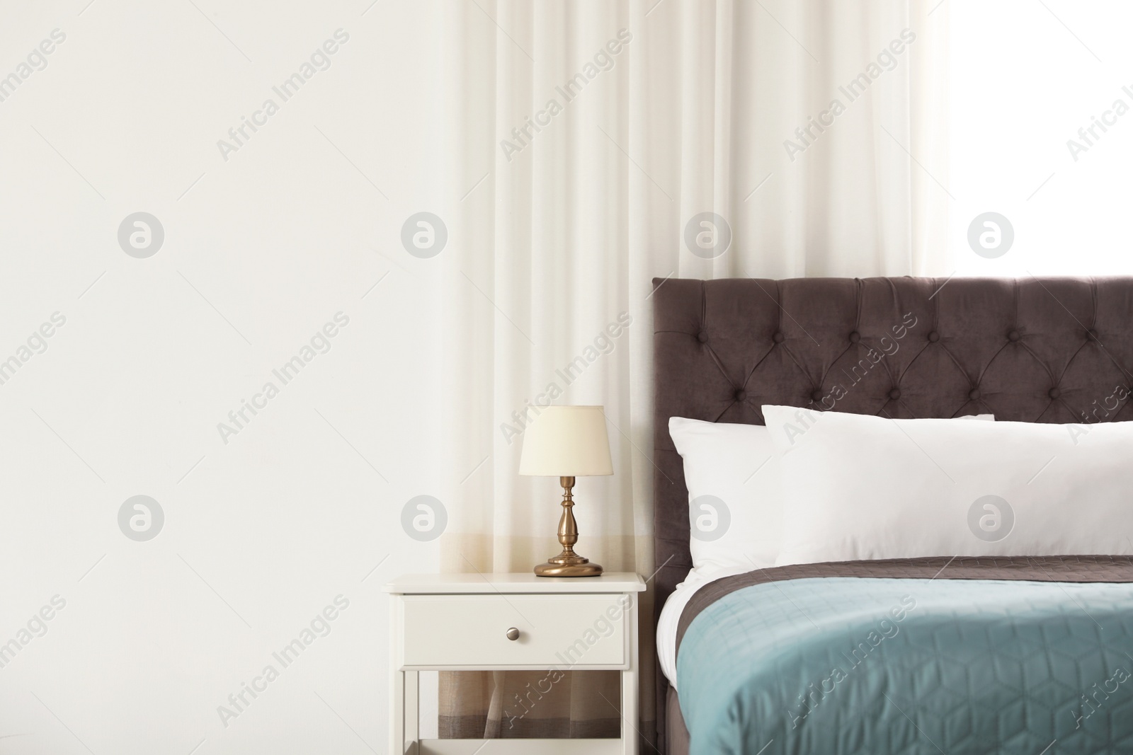 Photo of Modern comfortable bed in room, space for text. Interior design