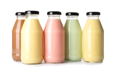 Photo of Bottles with different smoothies on white background