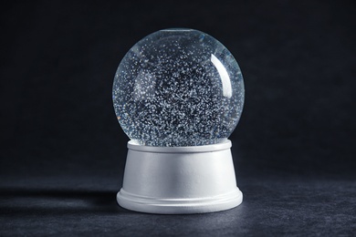 Photo of Magical empty snow globe on dark background