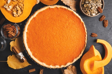 Photo of Flat lay composition with delicious homemade pumpkin pie on black table
