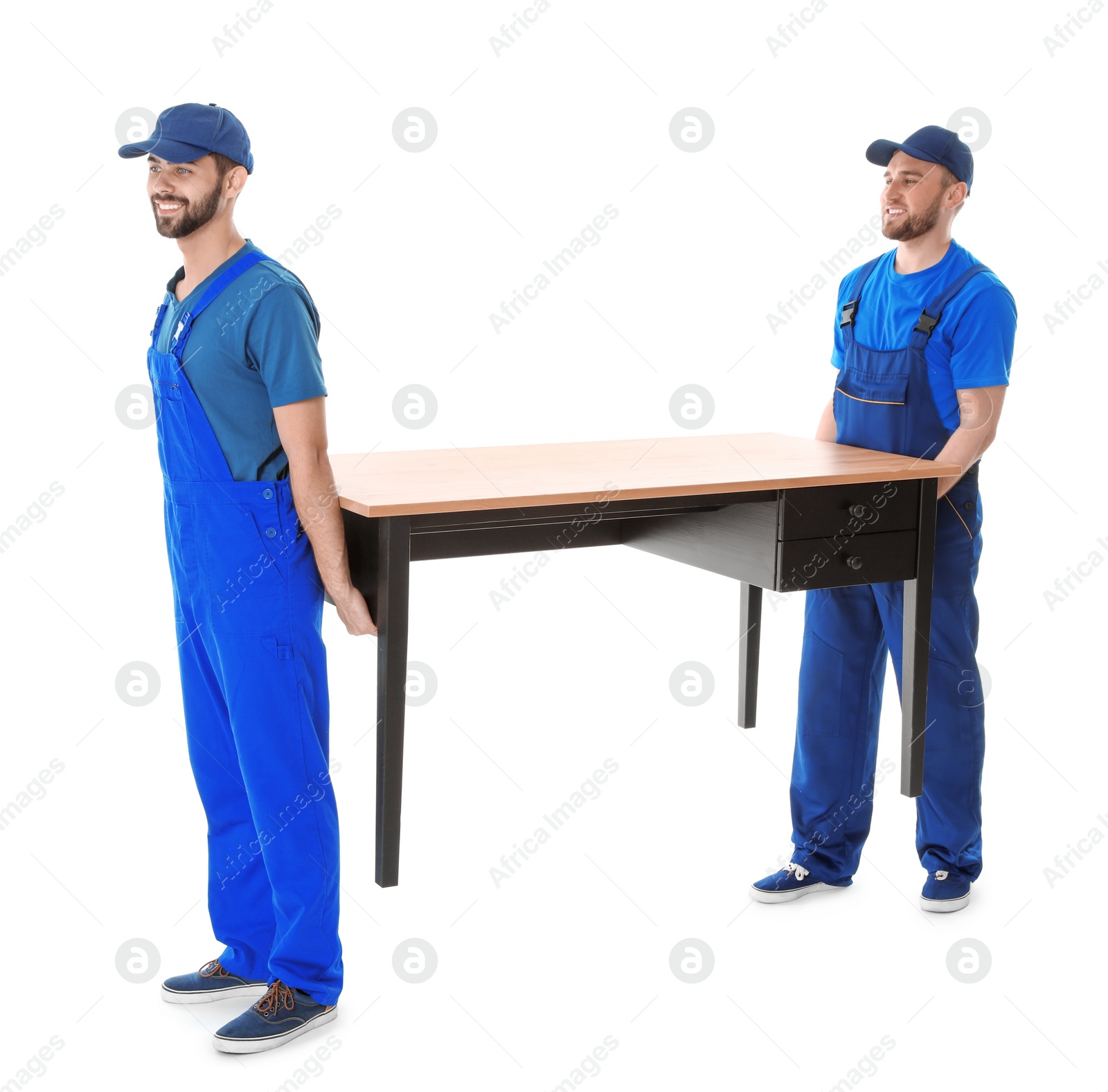 Photo of Young workers carrying table isolated on white. Moving service
